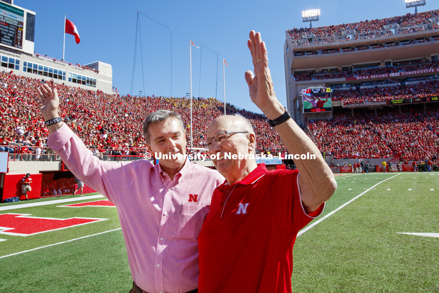 Former United States Agriculture Secretery Clayton Yeutter, right, and University of Nebraska Chancellor Ronnie Green wave to the crowd after Yeutter was honored on the field between the first and second quarters. Nebraska vs. Wyoming football. September 10, 2016. Photo by Craig Chandler / University Communication Photography.